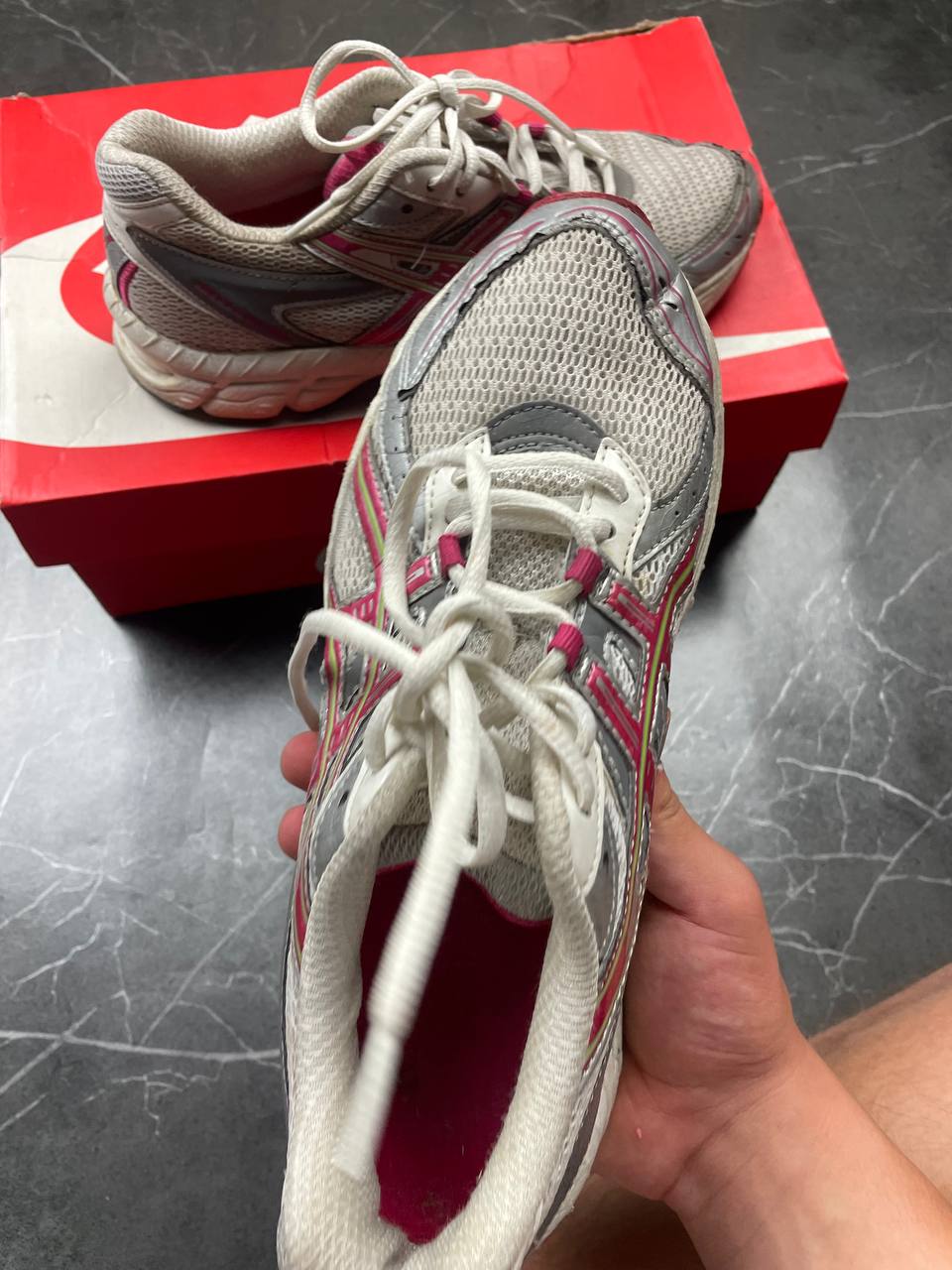 ASICS grey and pink running shoes with breathable mesh panels and rubber soles.