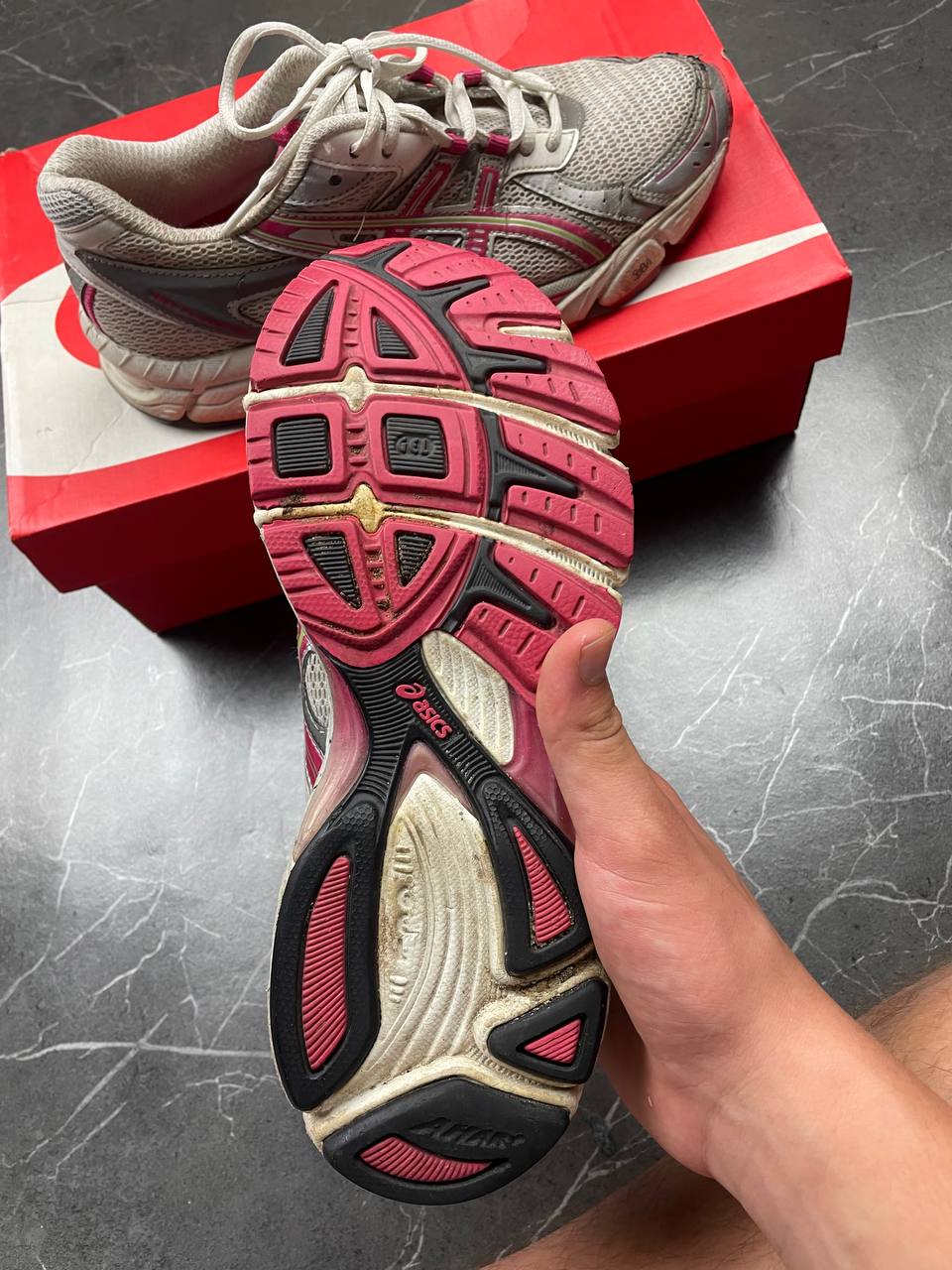 ASICS grey and pink running shoes with breathable mesh panels and rubber soles.