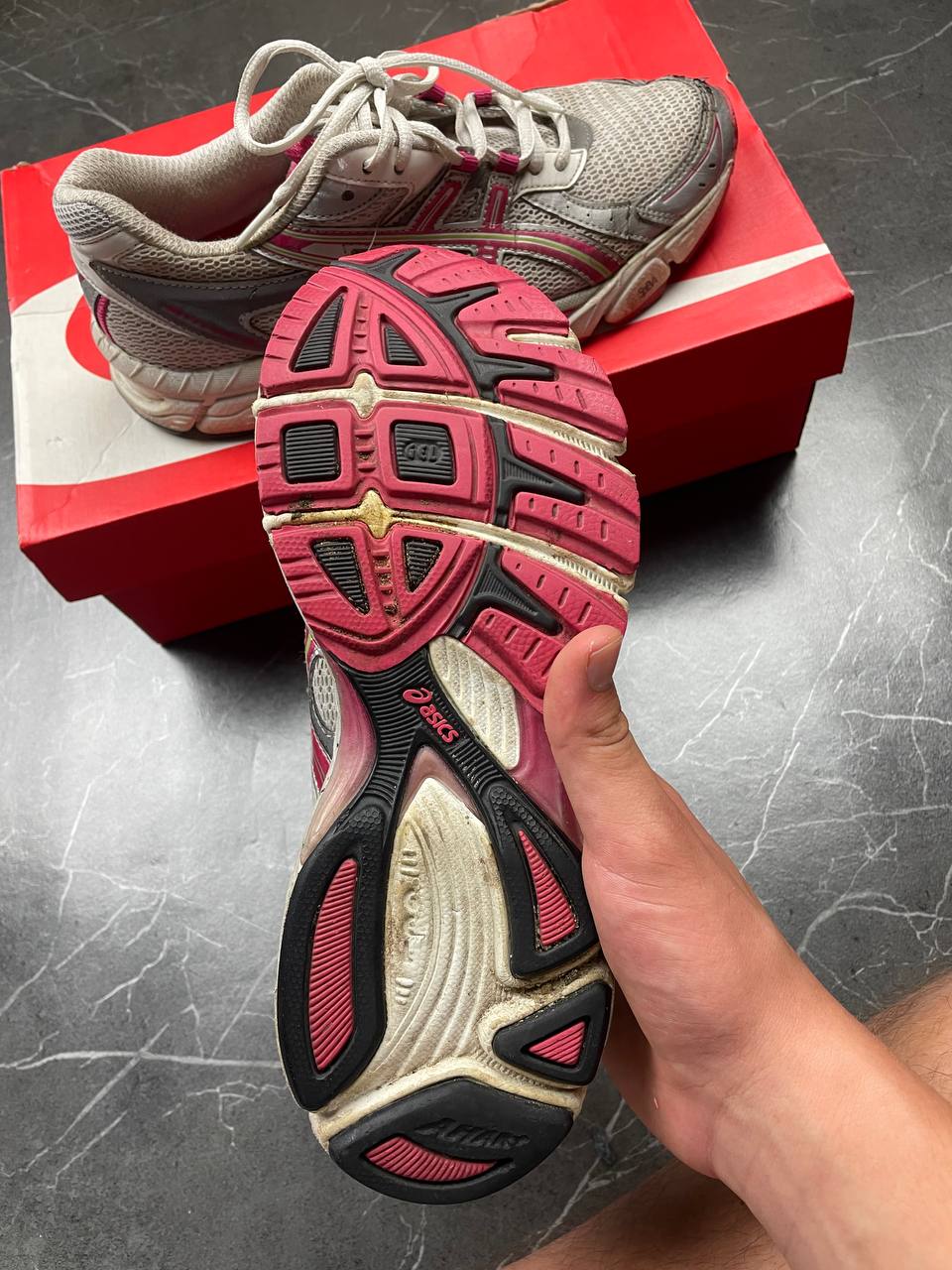 ASICS grey and pink running shoes with breathable mesh panels and rubber soles.