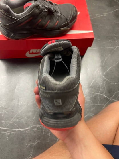 Salomon black and red trail running shoes with quick-lace closure and breathable mesh upper.