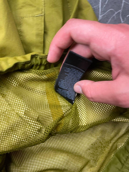 The North Face green hooded windbreaker jacket with branded patch and full zip front.