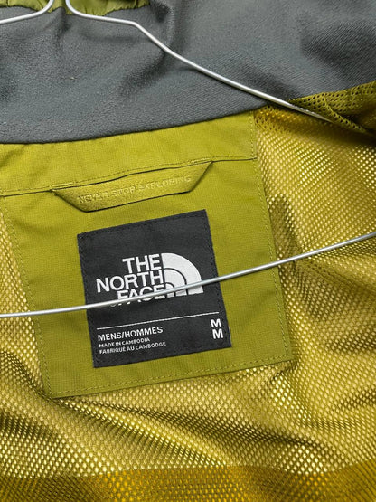 The North Face green hooded windbreaker jacket with branded patch and full zip front.
