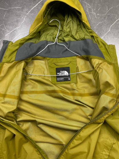 The North Face green hooded windbreaker jacket with branded patch and full zip front.