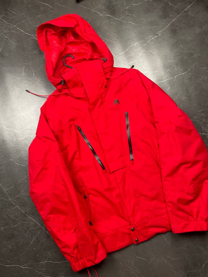 Nike red hooded jacket with waterproof zippers and adjustable hood, 100% polyester.