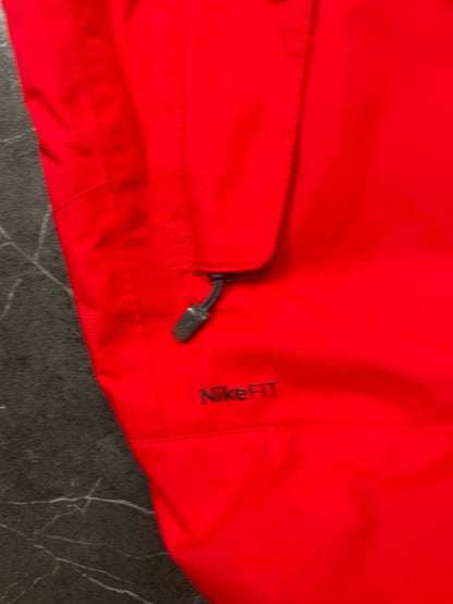 Nike red hooded jacket with waterproof zippers and adjustable hood, 100% polyester.