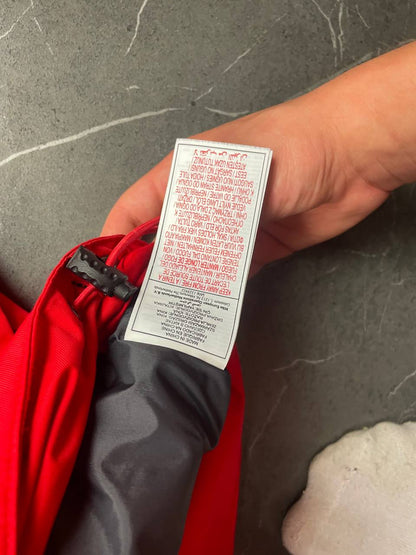 Nike red hooded jacket with waterproof zippers and adjustable hood, 100% polyester.