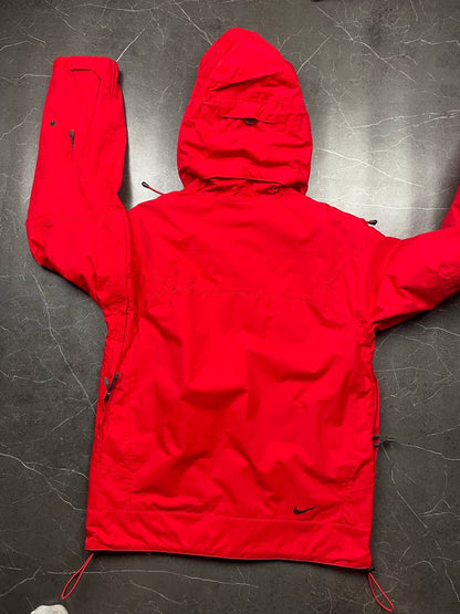 Nike red hooded jacket with waterproof zippers and adjustable hood, 100% polyester.