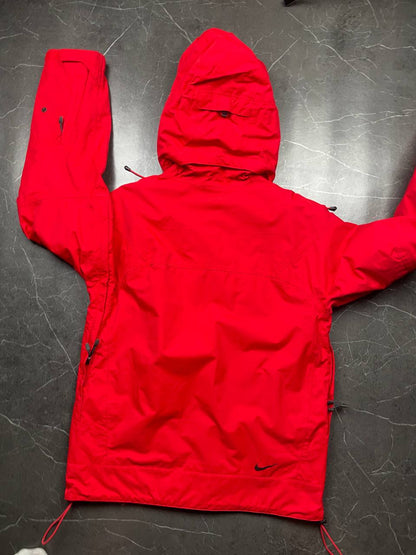 Nike red hooded jacket with waterproof zippers and adjustable hood, 100% polyester.