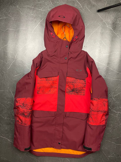 Oakley burgundy and red waterproof jacket with patterned accents and adjustable hood.