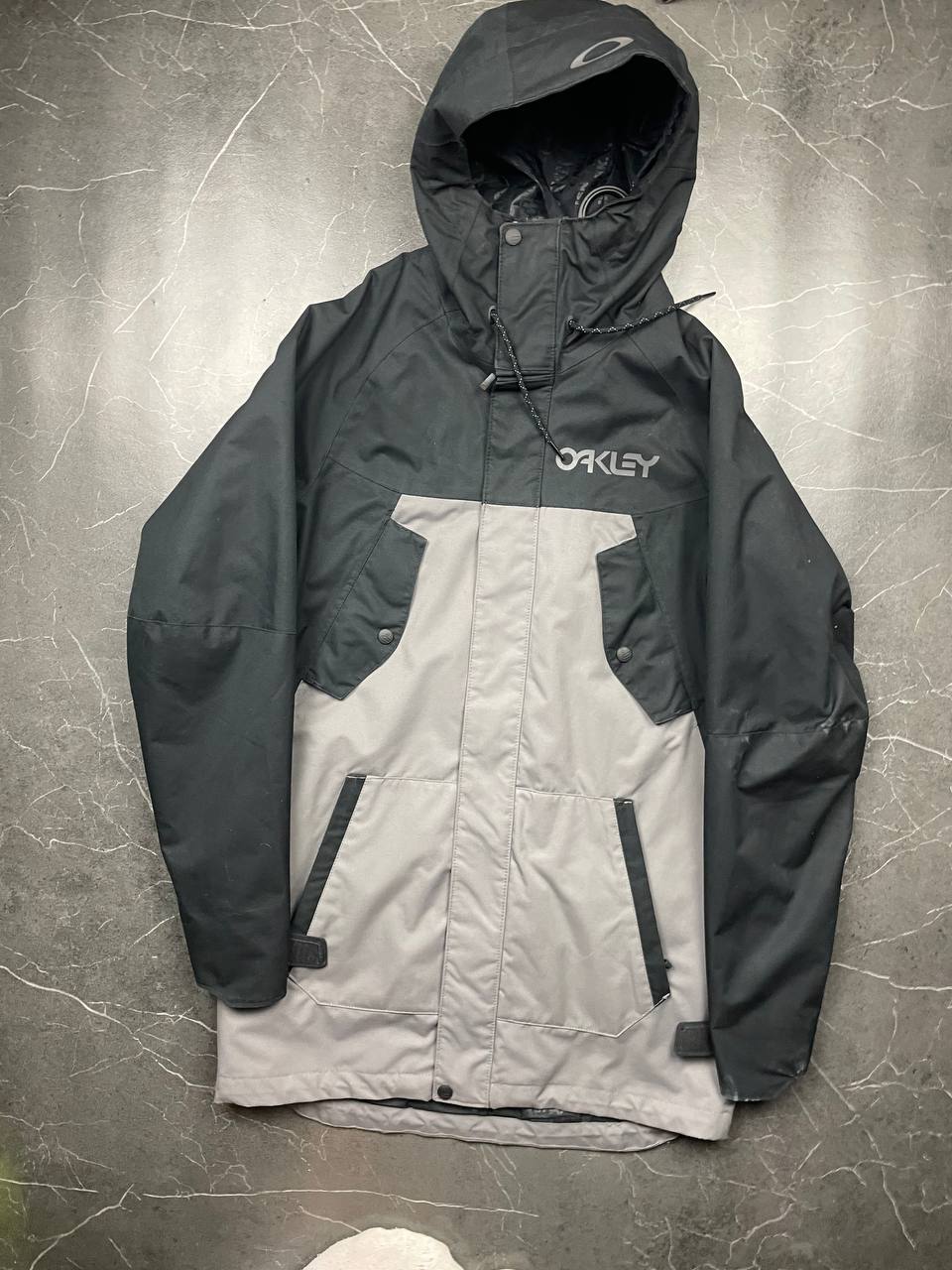 Oakley insulated hooded jacket black and grey with logo on chest and hood.