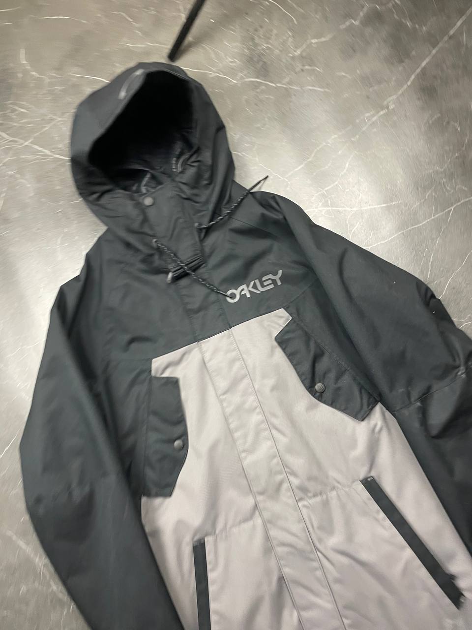 Oakley insulated hooded jacket black and grey with logo on chest and hood.