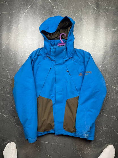 Nike ACG blue and brown waterproof jacket with Gore-Tex label and adjustable hood.