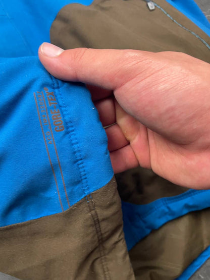 Nike ACG blue and brown waterproof jacket with Gore-Tex label and adjustable hood.