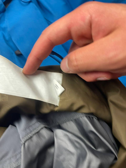Nike ACG blue and brown waterproof jacket with Gore-Tex label and adjustable hood.
