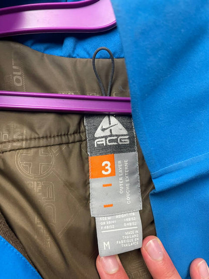 Nike ACG blue and brown waterproof jacket with Gore-Tex label and adjustable hood.