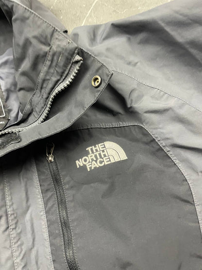 The North Face black and grey waterproof jacket with hood and chest pocket.