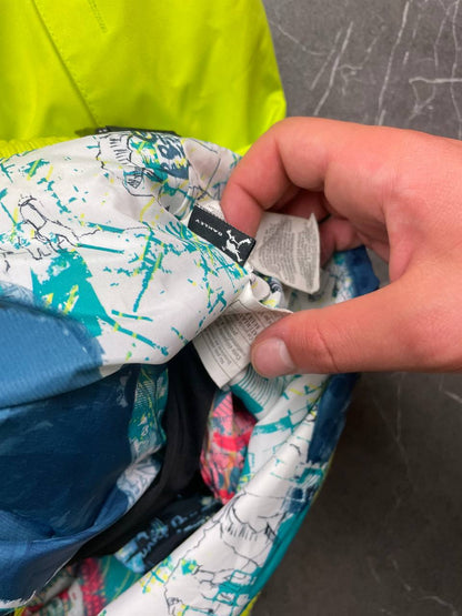 Oakley lime green ski jacket with hood, multicolored interior lining, logo on chest.