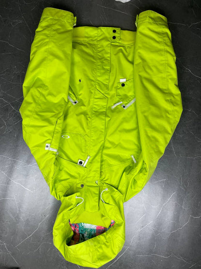 Oakley lime green ski jacket with hood, multicolored interior lining, logo on chest.