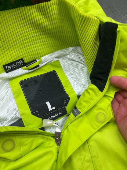 Oakley lime green ski jacket with hood, multicolored interior lining, logo on chest.