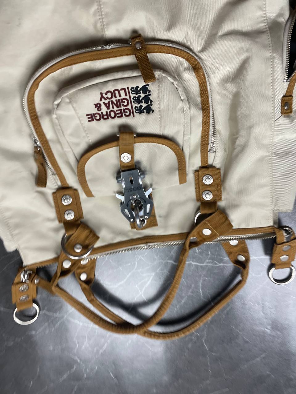 George Gina & Lucy beige canvas shoulder bag with brown straps and embroidered logo.