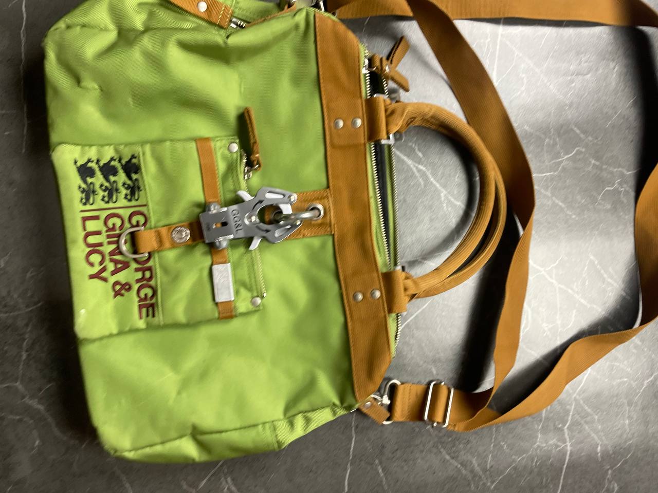George Gina & Lucy brown and green shoulder bag with embroidered logo and metal clasp.