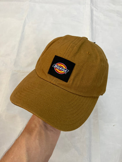 Dickies brown canvas baseball cap with logo patch and adjustable strap.
