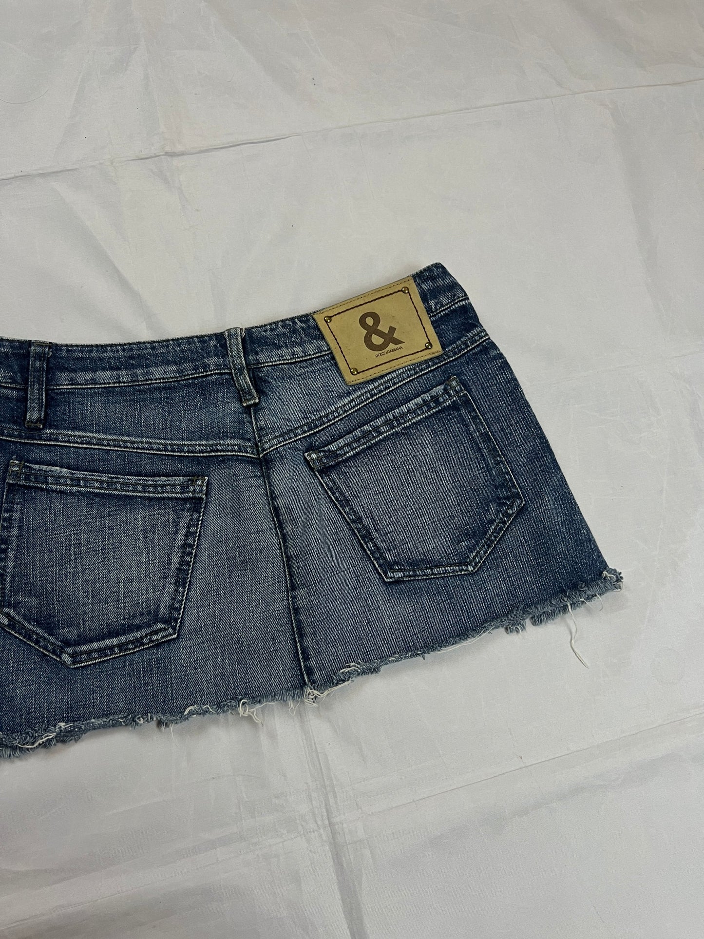 & Other Stories blue denim mini skirt with frayed hem and branded button fly closure