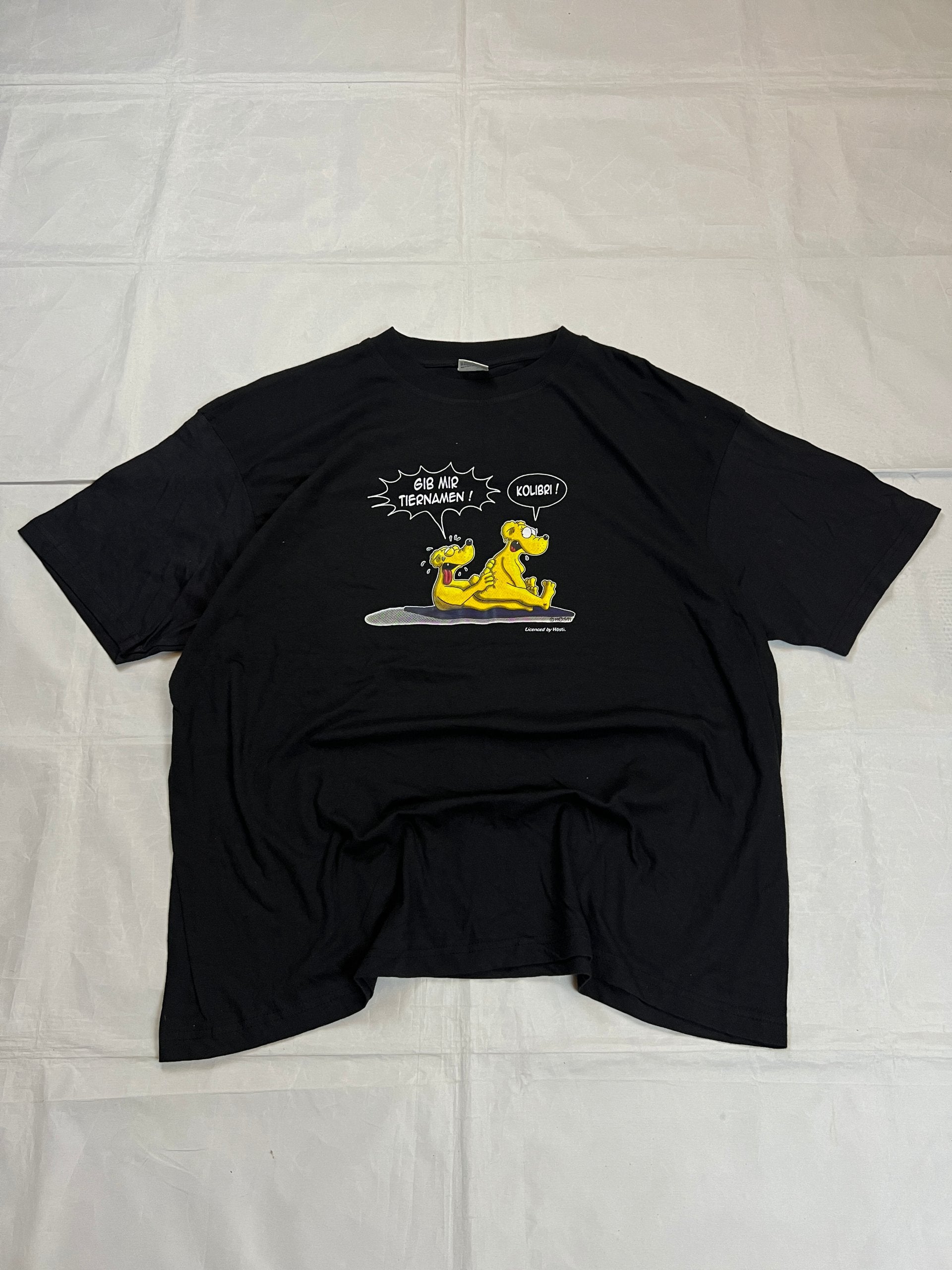 Carhartt black graphic cotton t-shirt with yellow cartoon design and printed text.