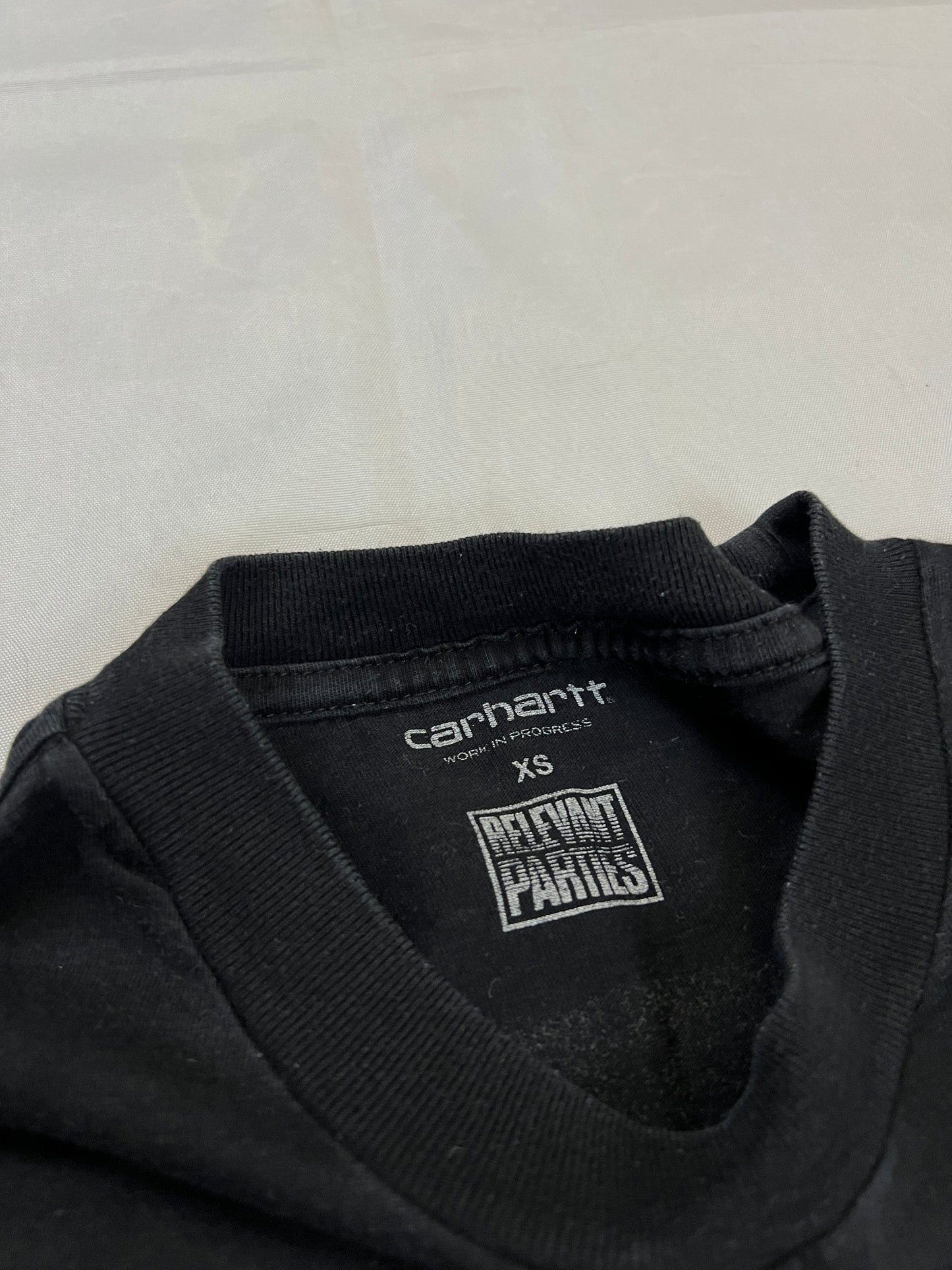 Carhartt black graphic cotton t-shirt with yellow cartoon design and printed text.