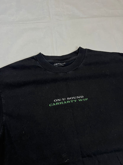 Carhartt black graphic cotton t-shirt with yellow cartoon design and printed text.