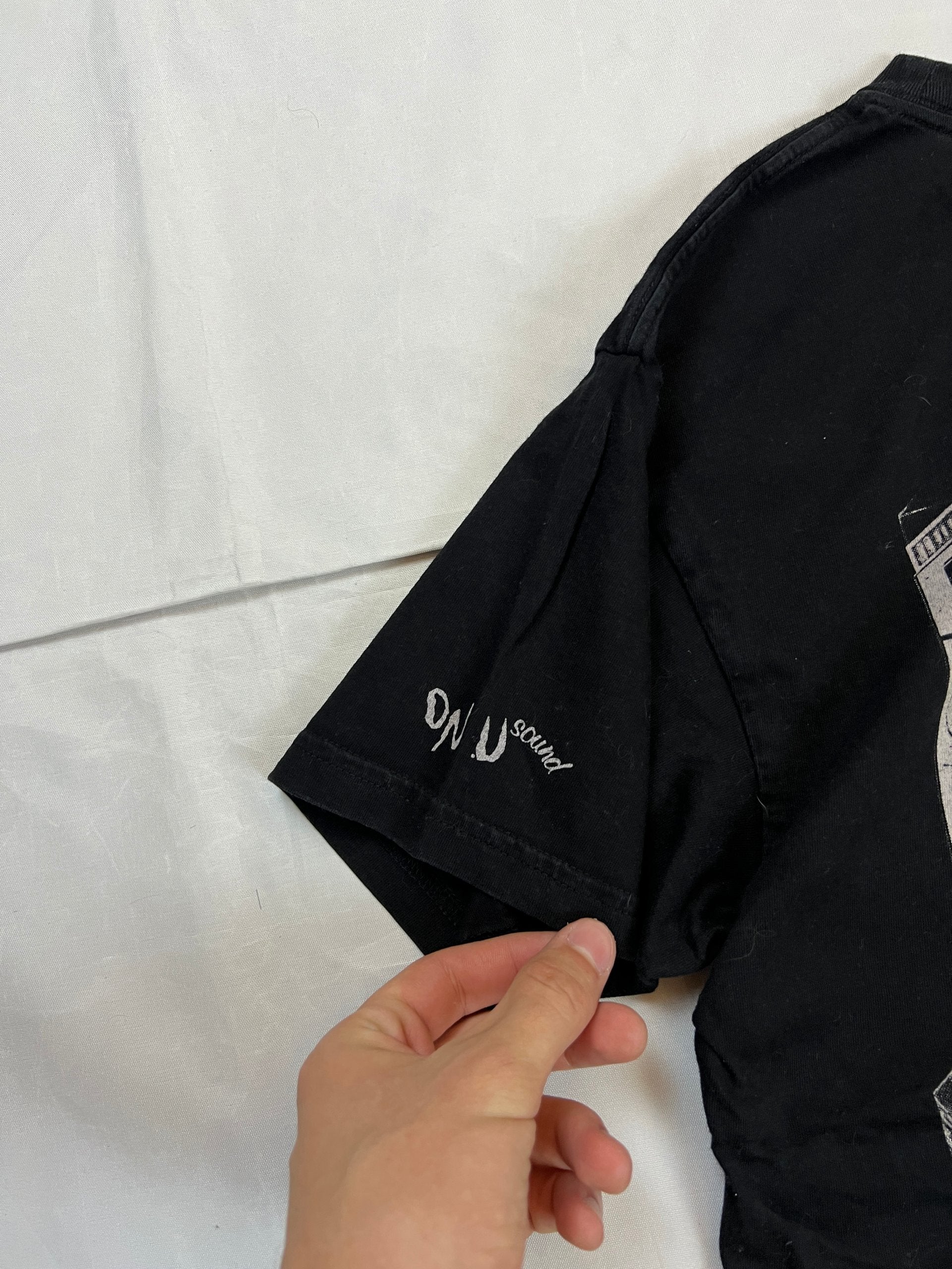 Carhartt black graphic cotton t-shirt with yellow cartoon design and printed text.