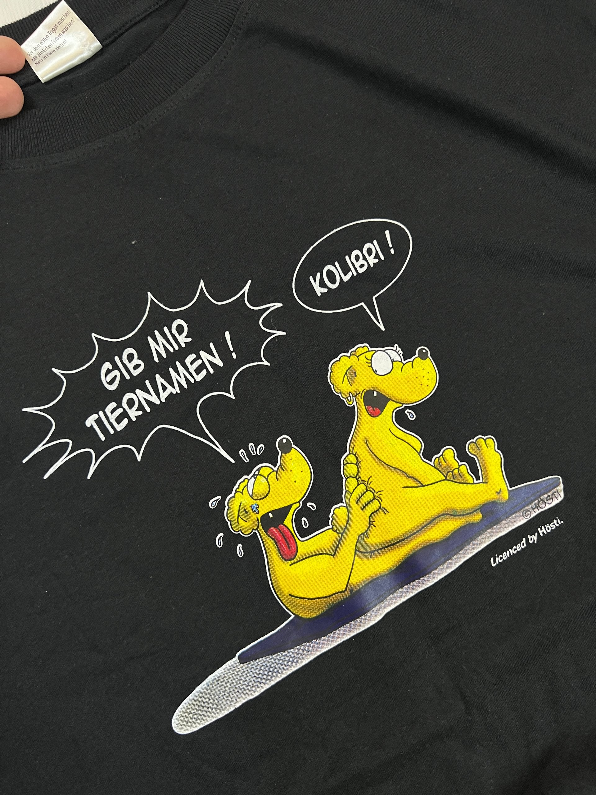 Carhartt black graphic cotton t-shirt with yellow cartoon design and printed text.