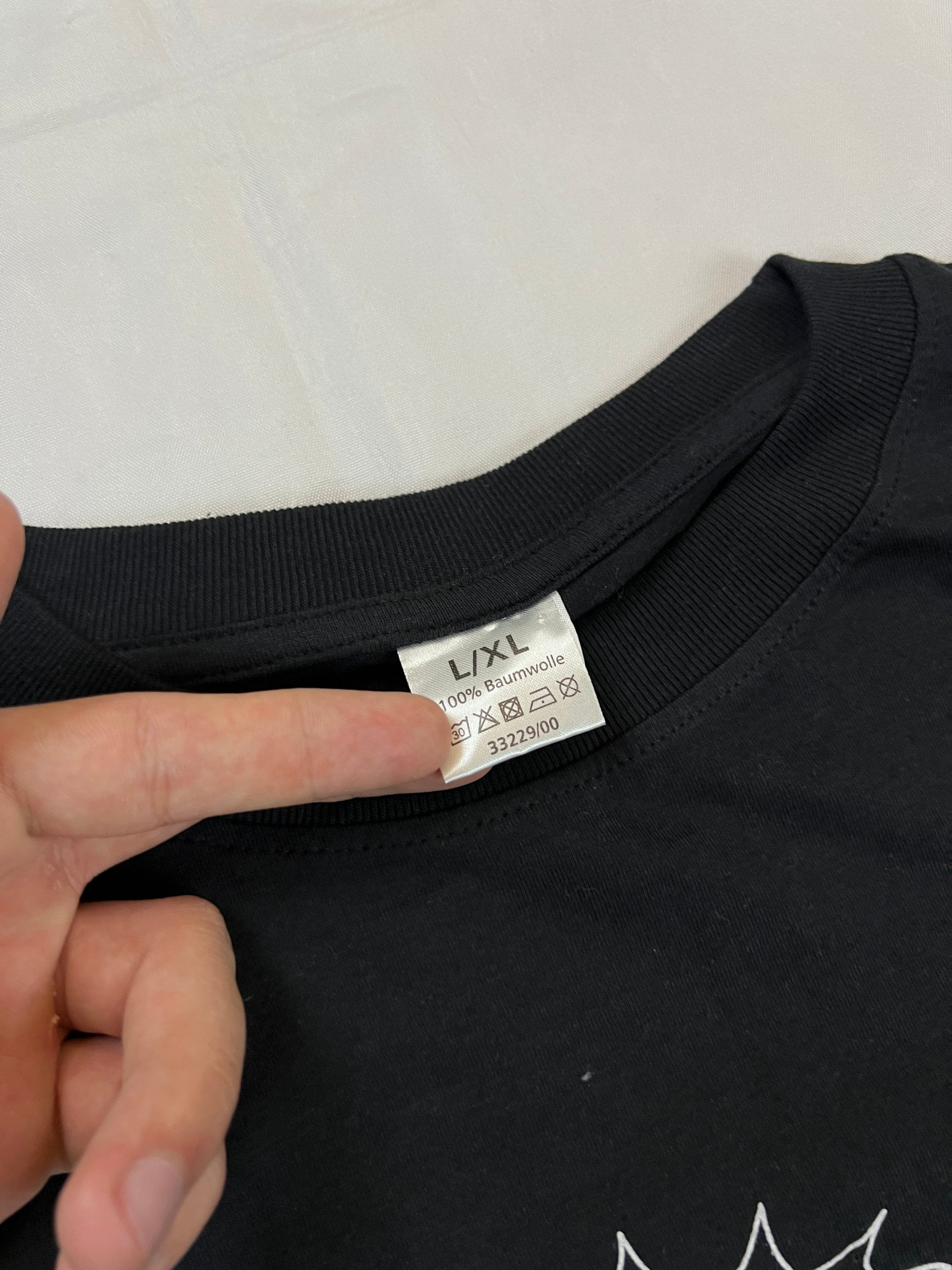 Carhartt black graphic cotton t-shirt with yellow cartoon design and printed text.