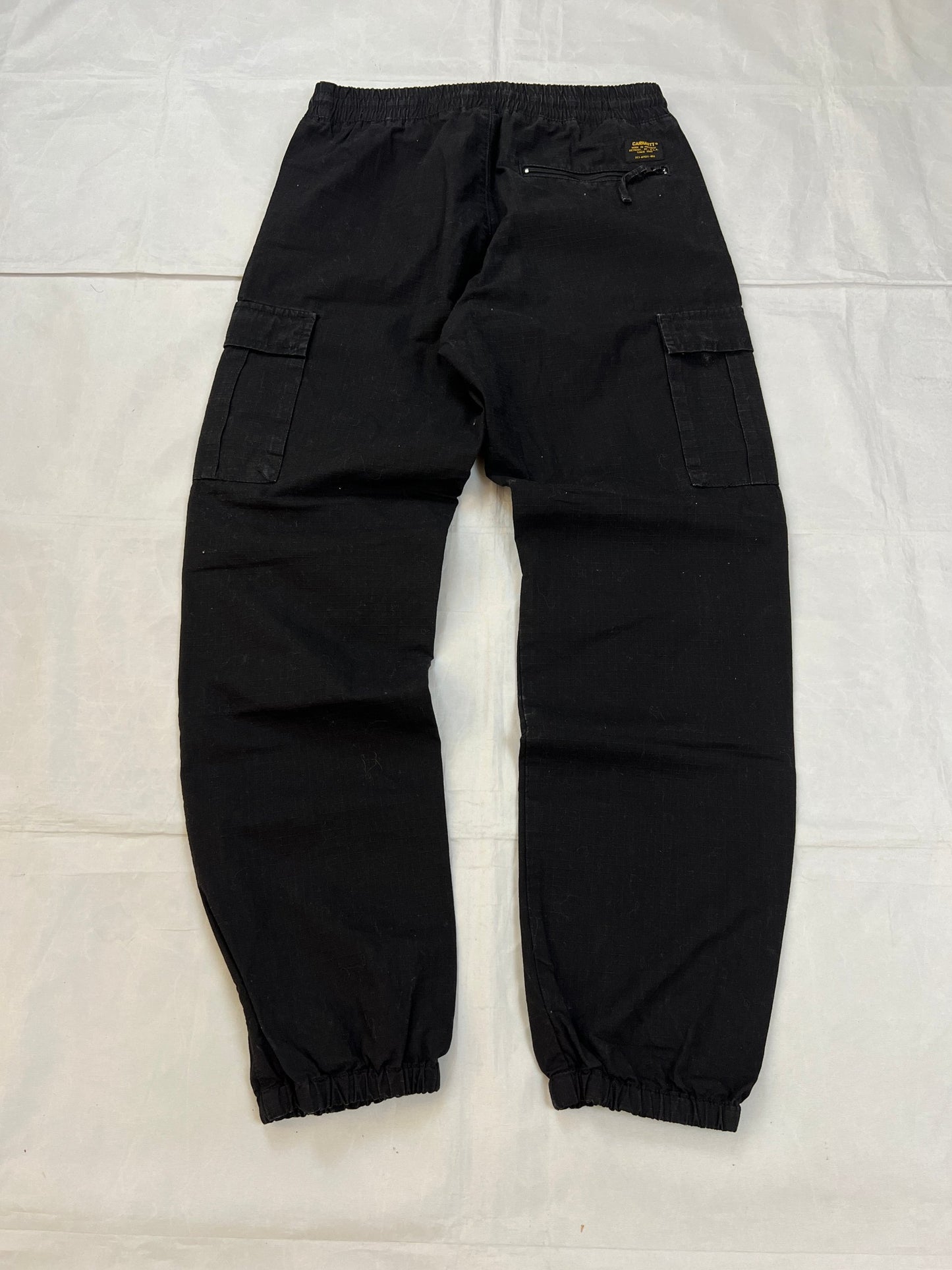 Carhartt black cargo joggers relaxed fit with multiple pockets and elastic cuffs.