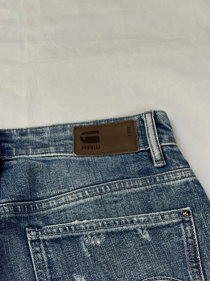 G-Star Raw blue distressed denim jeans with frayed hems and slit detail.