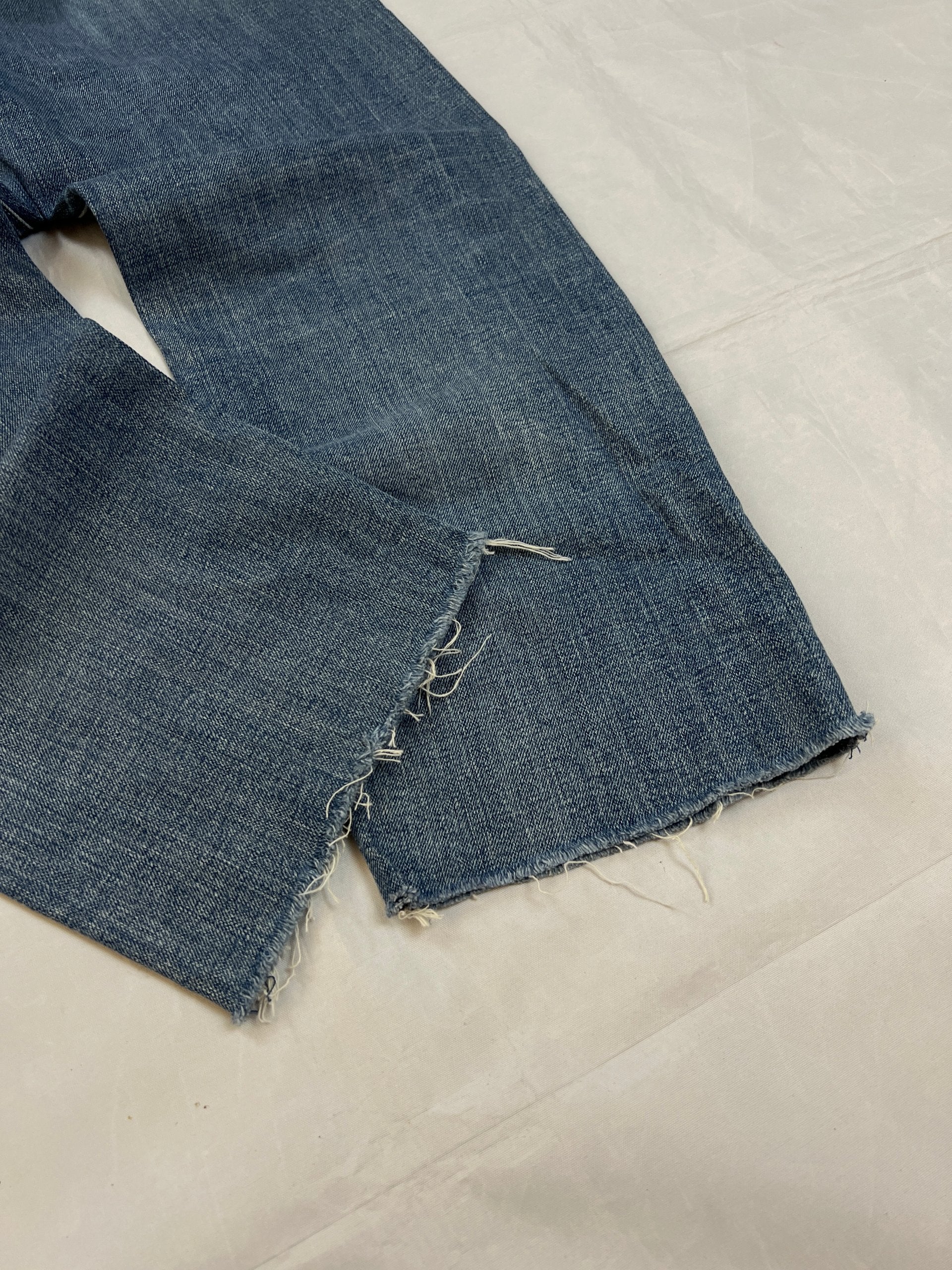 G-Star Raw blue distressed denim jeans with frayed hems and slit detail.