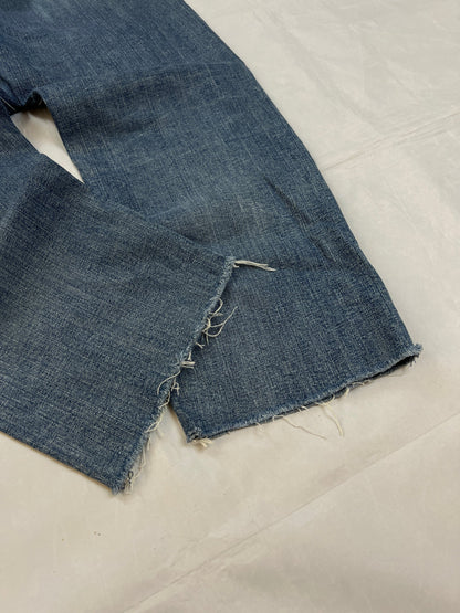 G-Star Raw blue distressed denim jeans with frayed hems and slit detail.