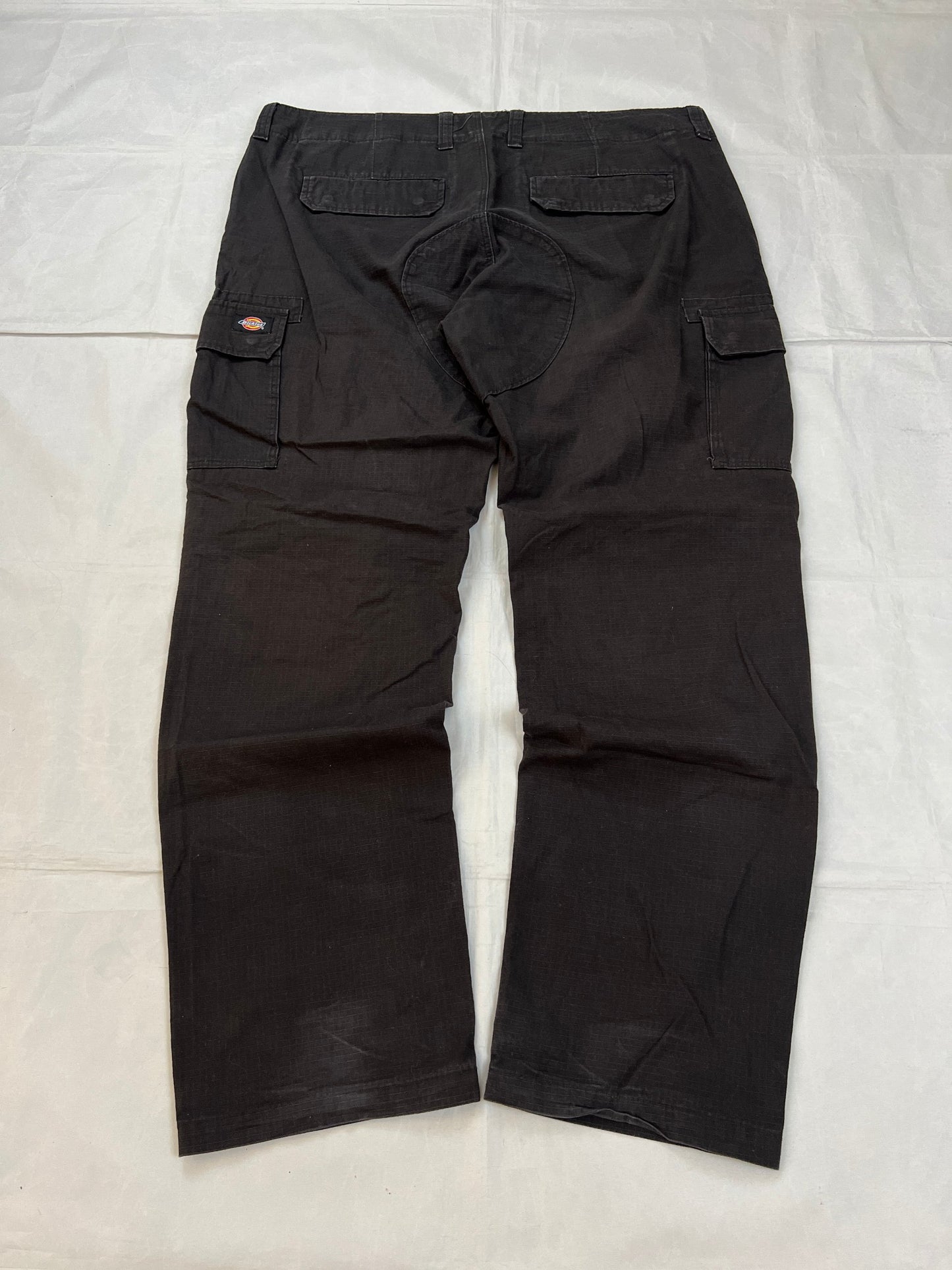 Dickies black cargo trousers with functional snap pockets and reinforced seat patch.