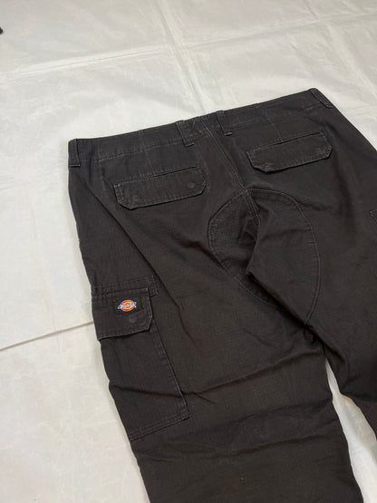 Dickies black cargo trousers with functional snap pockets and reinforced seat patch.