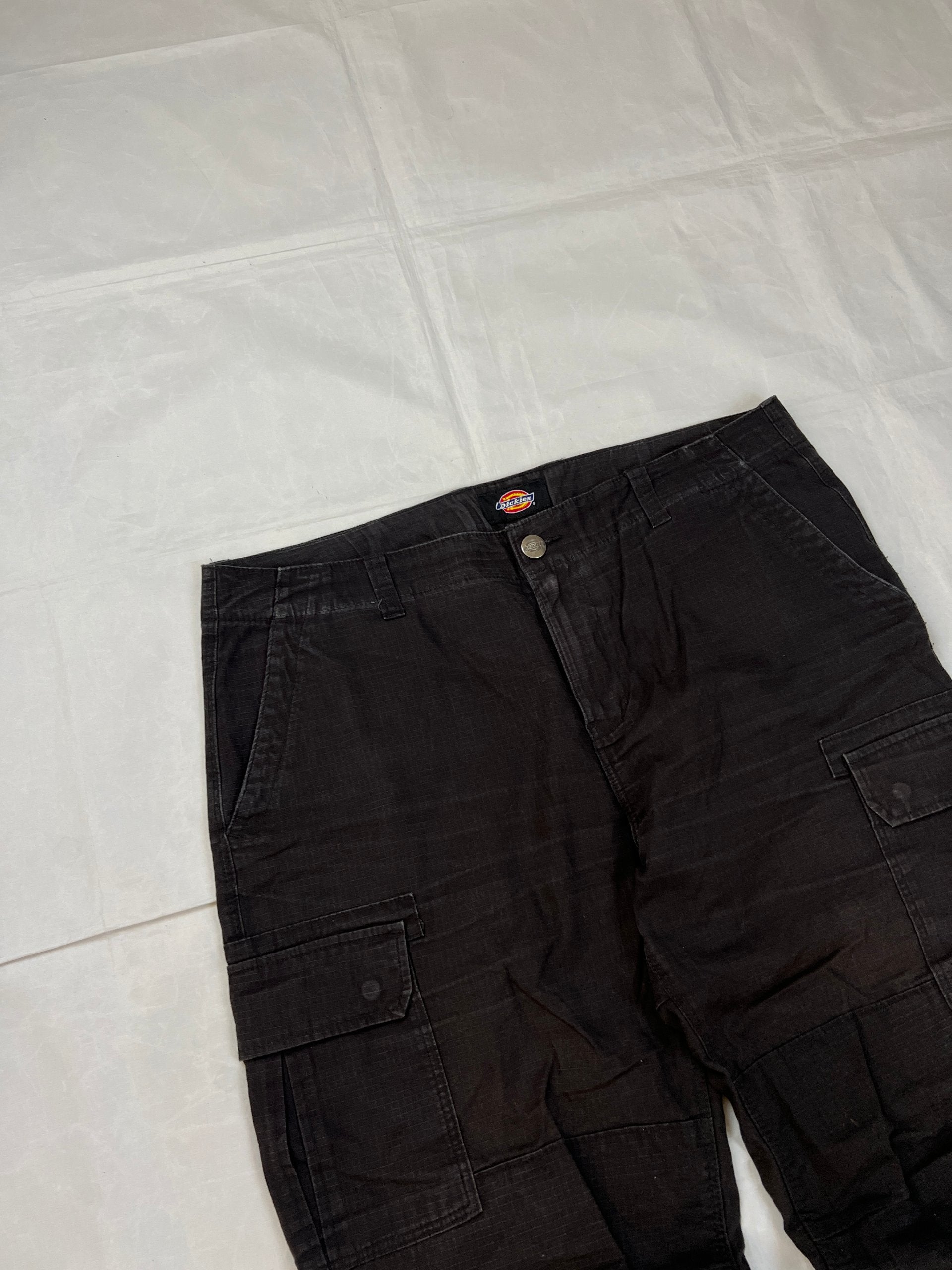 Dickies black cargo trousers with functional snap pockets and reinforced seat patch.