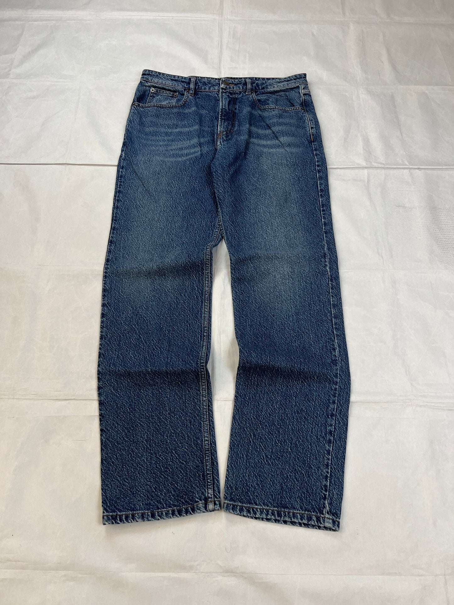 Balenciaga blue denim jeans with five-pocket styling and branded patch at back waist.