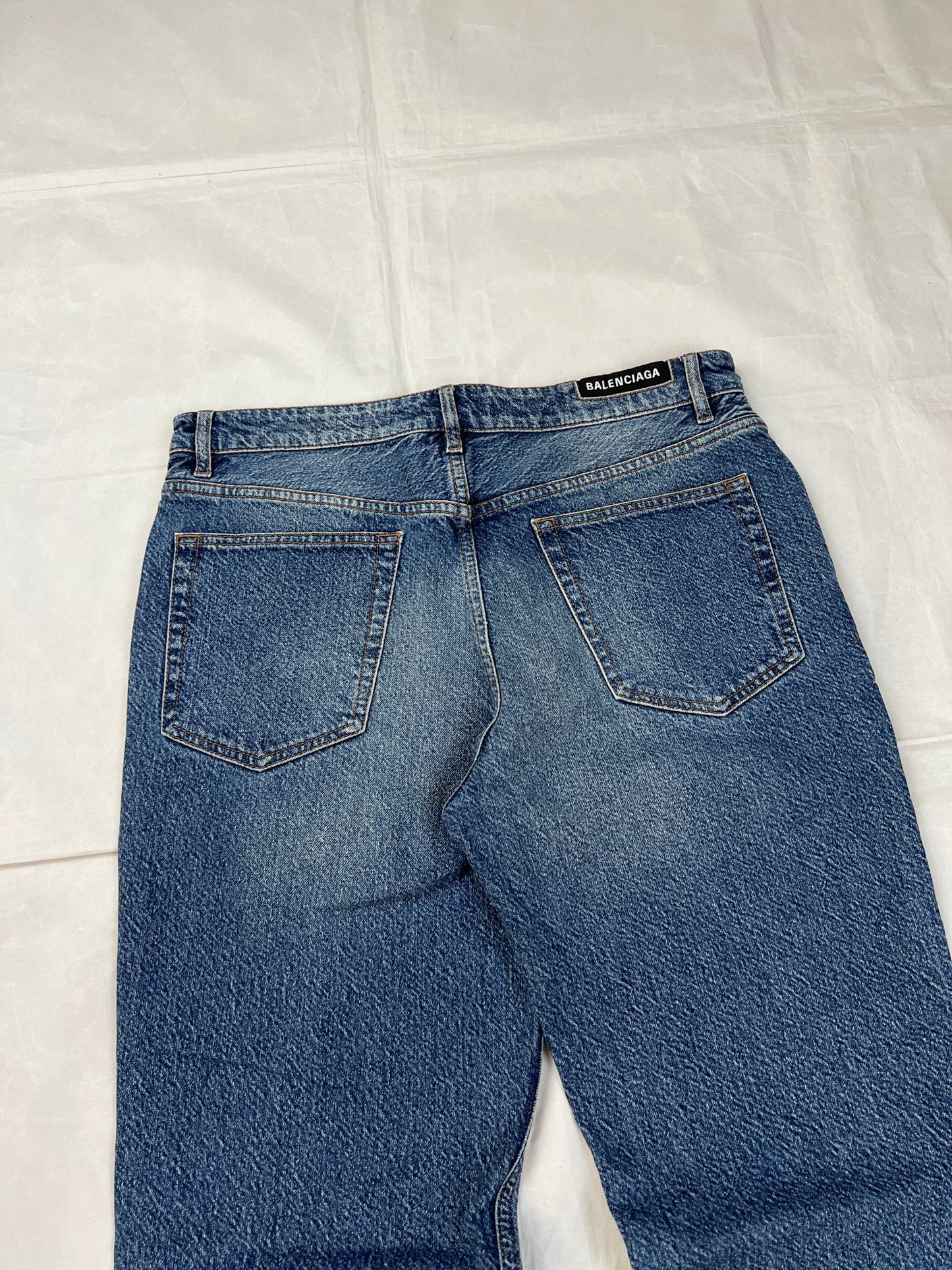 Balenciaga blue denim jeans with five-pocket styling and branded patch at back waist.