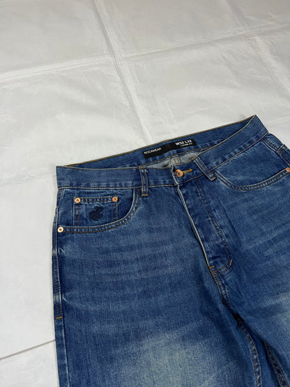 Rocawear blue denim loose fit jeans with faded effect and embroidered back pocket details.