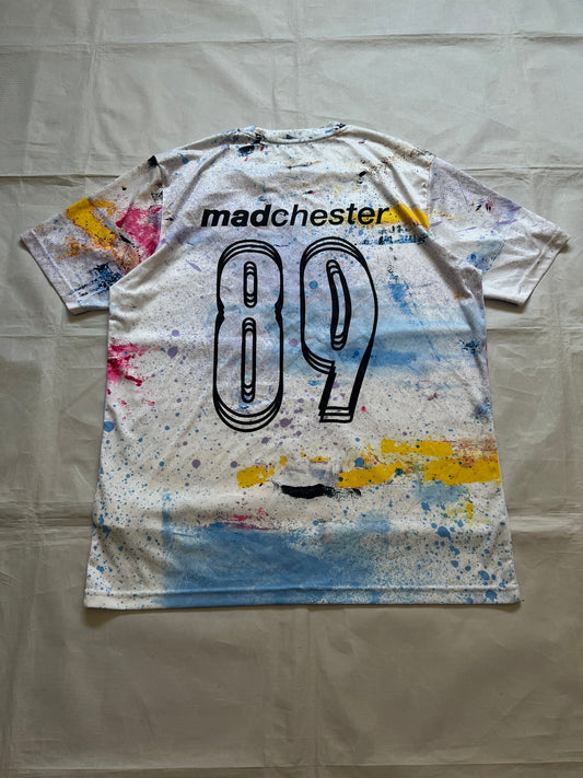 Puma blue and white football jersey with Manchester City crest and splatter paint design.