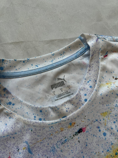 Puma blue and white football jersey with Manchester City crest and splatter paint design.