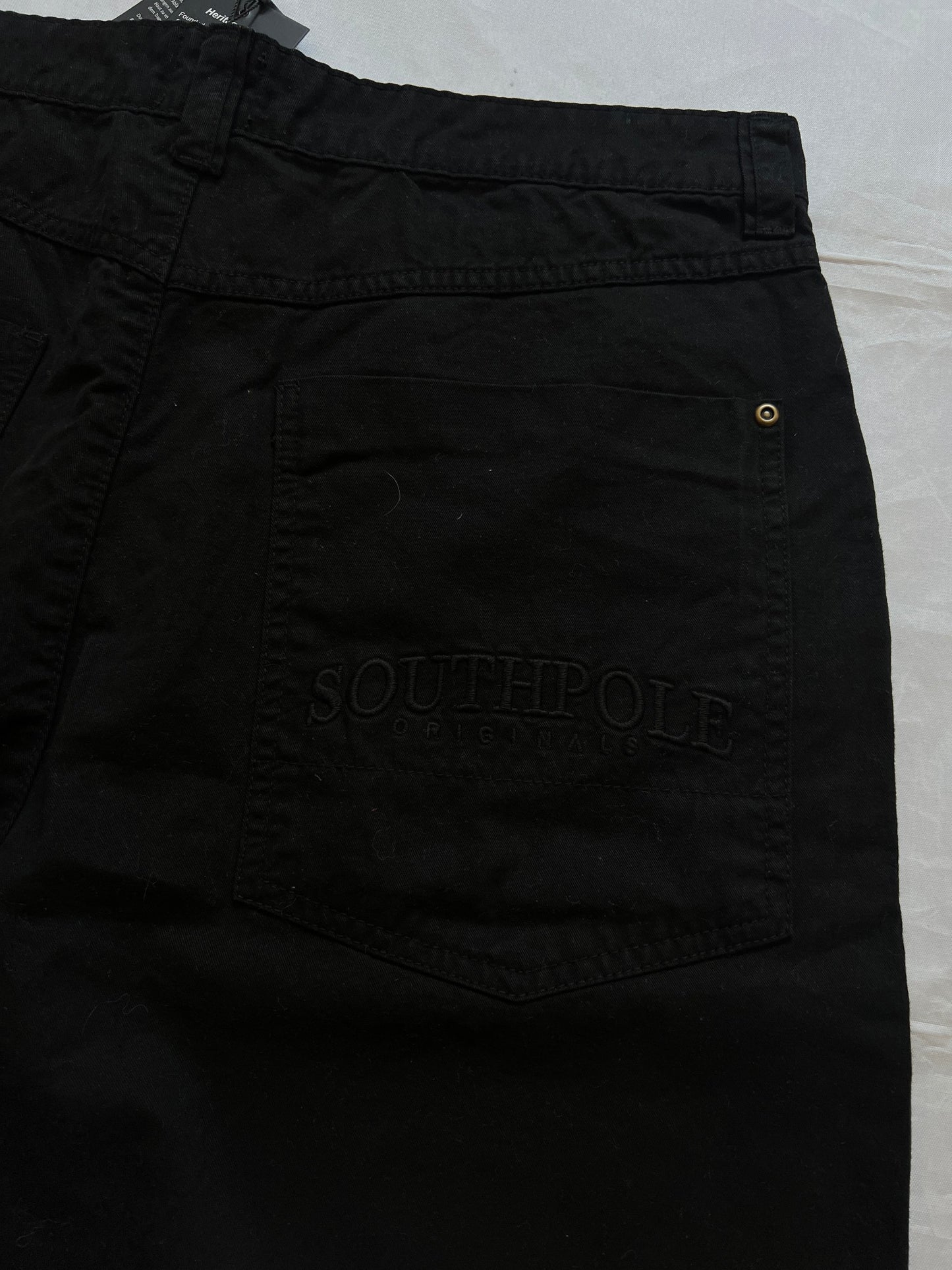 Southpole black denim shorts size 36 with bronze button detailing and embroidered logo.