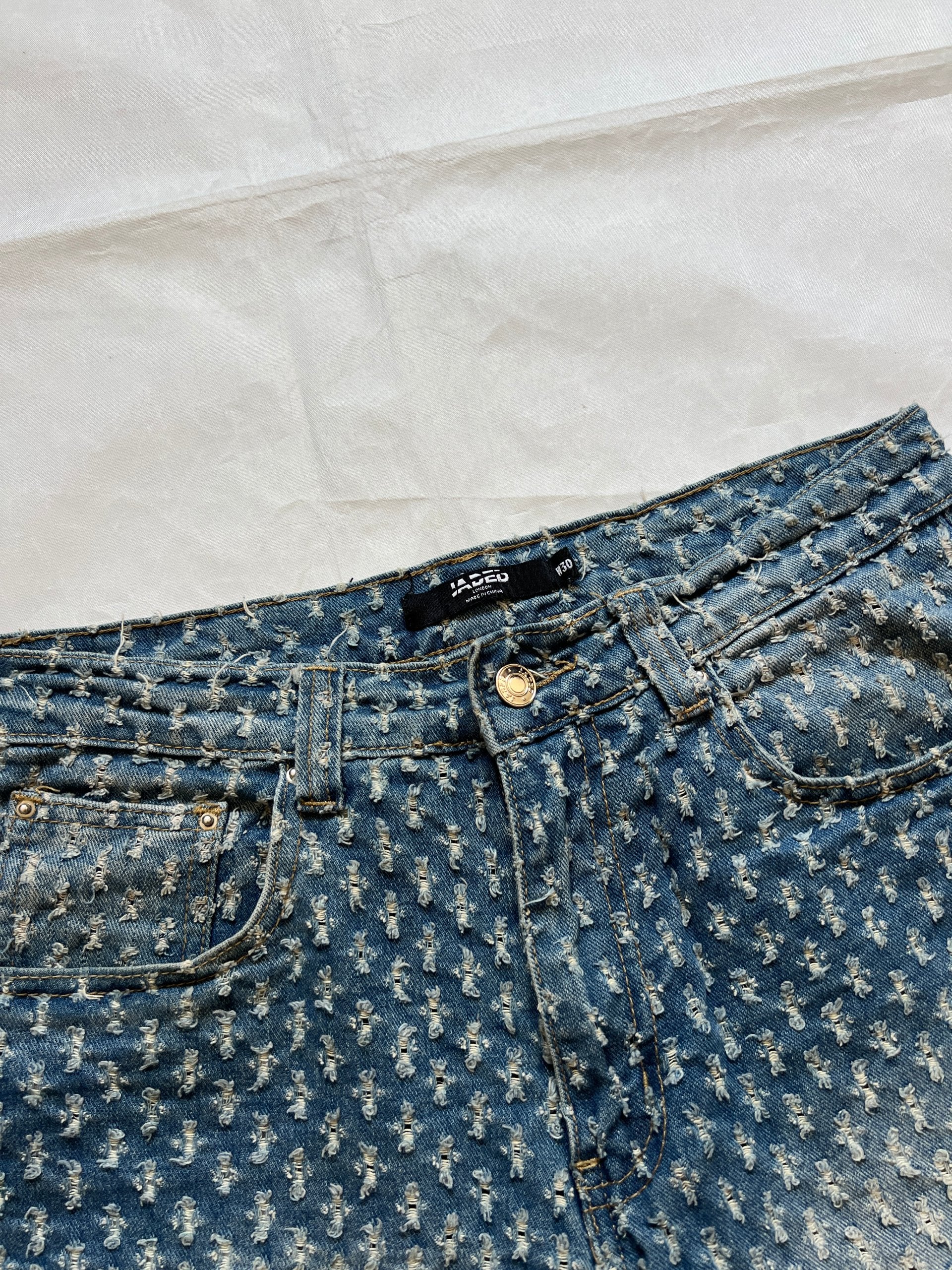 Based NY blue baggy fit denim shorts with distressed pattern and brass rivet details.