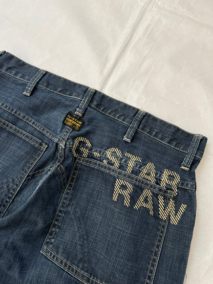 G-Star Raw blue denim jeans with embroidered logo, distinctive seam detailing, and large back pockets.