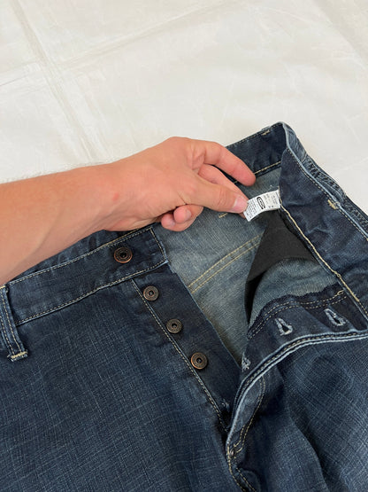 G-Star Raw blue denim jeans with embroidered logo, distinctive seam detailing, and large back pockets.