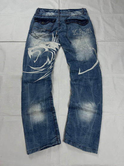 KJM blue denim jeans with white embroidered lion and logo, patchwork stitch detailing.